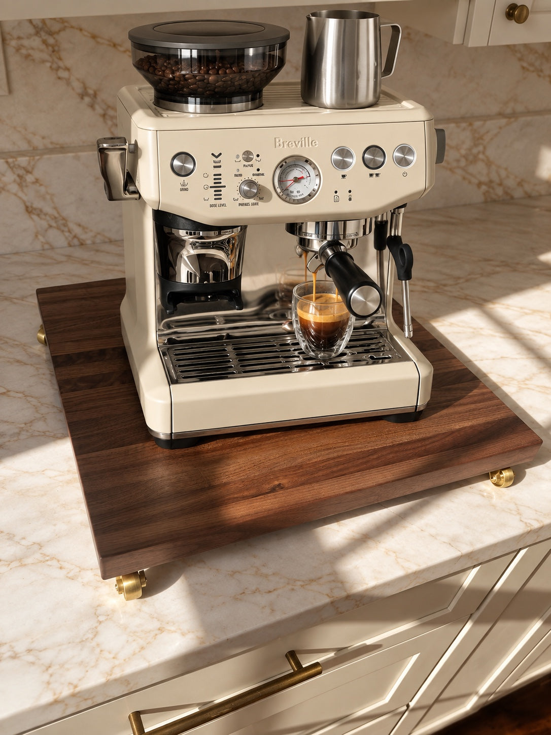Cream Breville espresso machine brewing on The Press walnut rolling platform