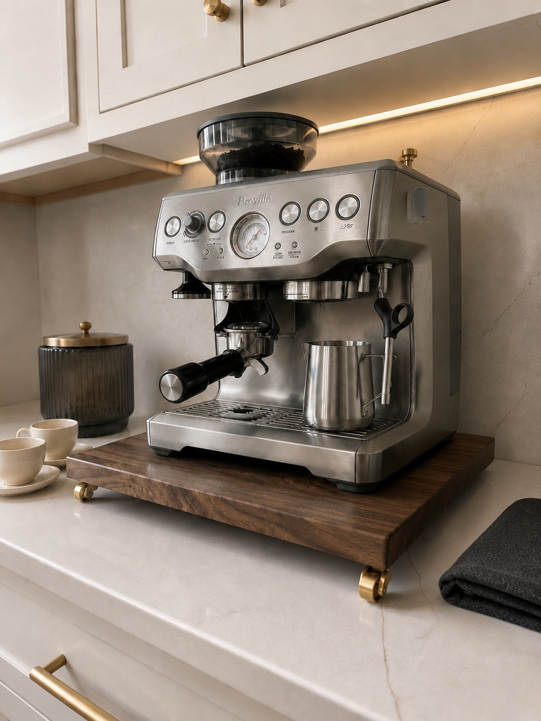 Stainless Breville espresso machine on The Press walnut rolling platform in a modern kitchen
