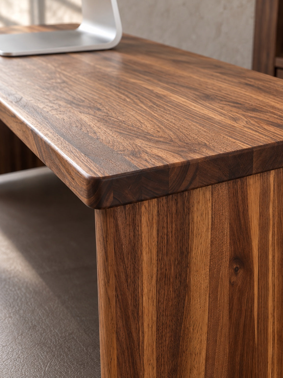 Close detail of The Archive's walnut top and softly rounded edge