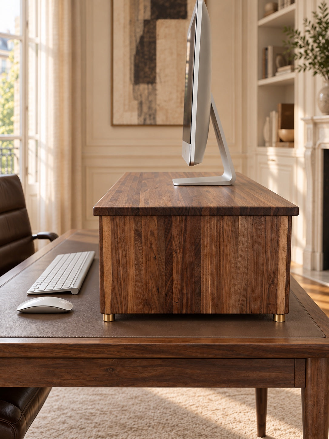 Side profile of The Archive walnut monitor stand with a slim desktop monitor
