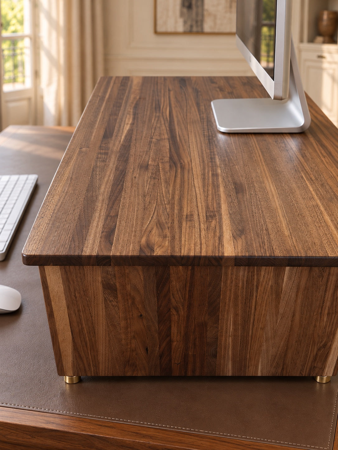 The Archive monitor riser viewed from above, showing solid walnut grain