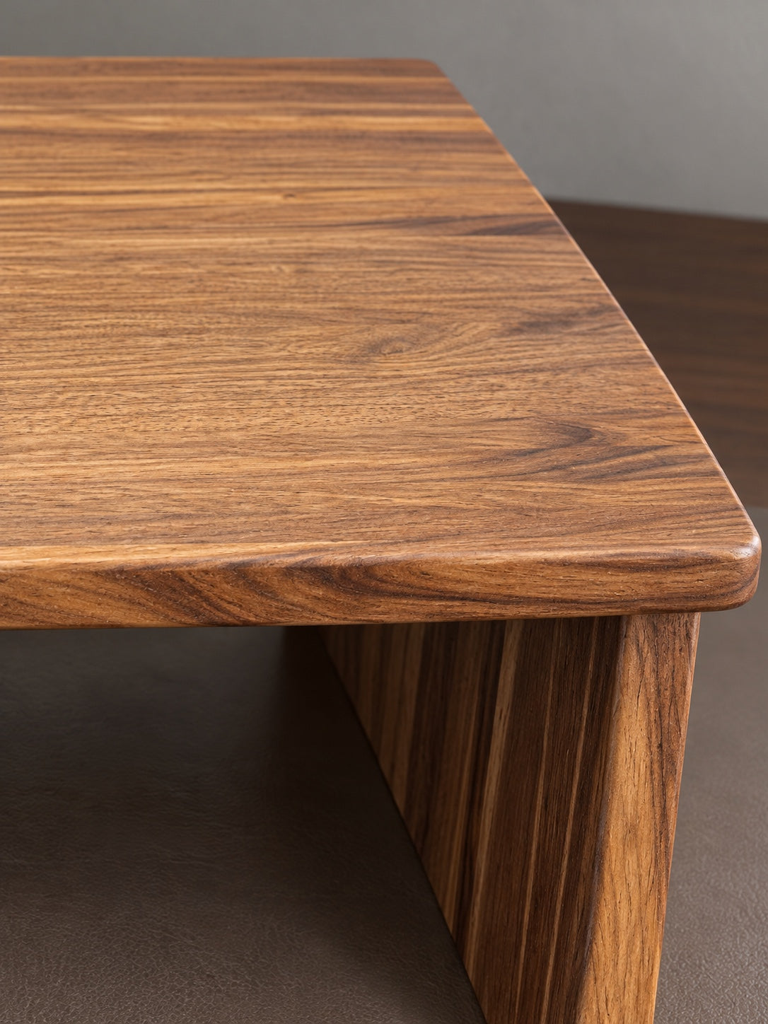 Walnut grain and rounded corner detail on The Archive monitor stand
